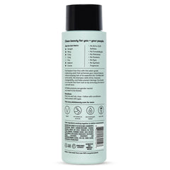 Odele smoothing shampoo flat lay with scent notes of oakmoss, ylang-ylang, cucumber