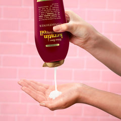 OGX Frizz-Free + Keratin Smoothing Oil Conditioner tub with keratin and argan oil nourishes smoother hair