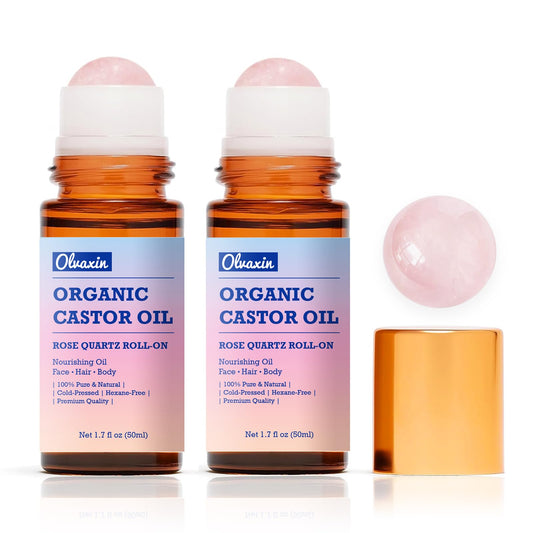Olvaxin castor oil roll-on with rose quartz bottle for targeted hydration.