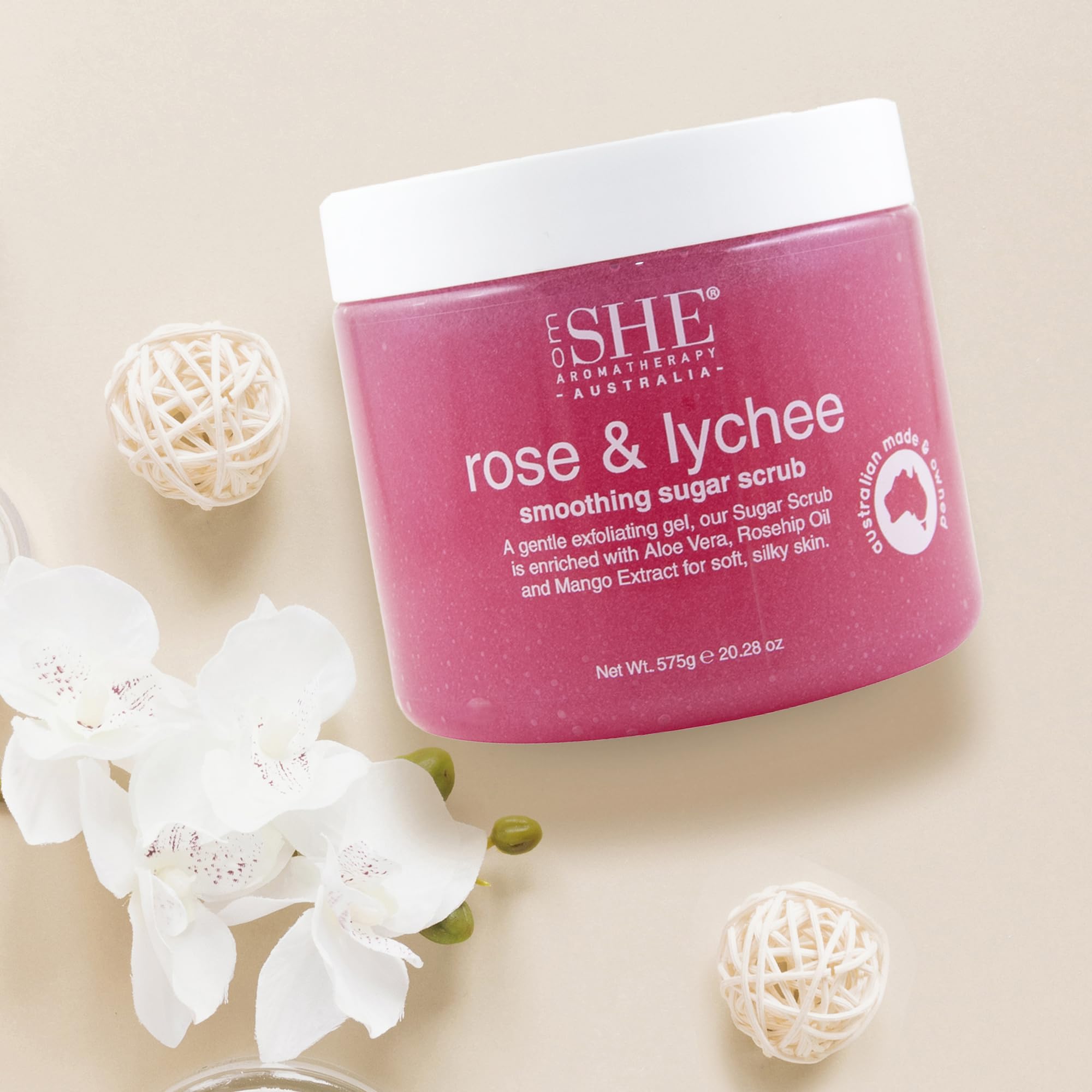 Australian-made Om She Rose and Lychee scrub bottle on display for skin nourishment