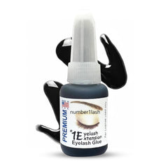 One Eyelash Extension premium adhesive bottle pour showing precise flow for lash placement