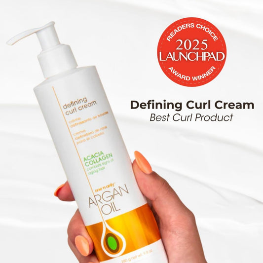 One 'N Only Defining Curl Cream bottle applying product for defined curls.