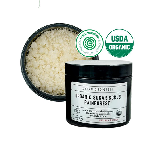 Organic To Green Rainforest Sugar Coconut Oil Scrub jar shows moisturizing texture that absorbs without greasiness