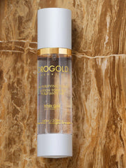 Orogold White Gold 24K Purifying Toner on a cotton pad ready for gentle application.