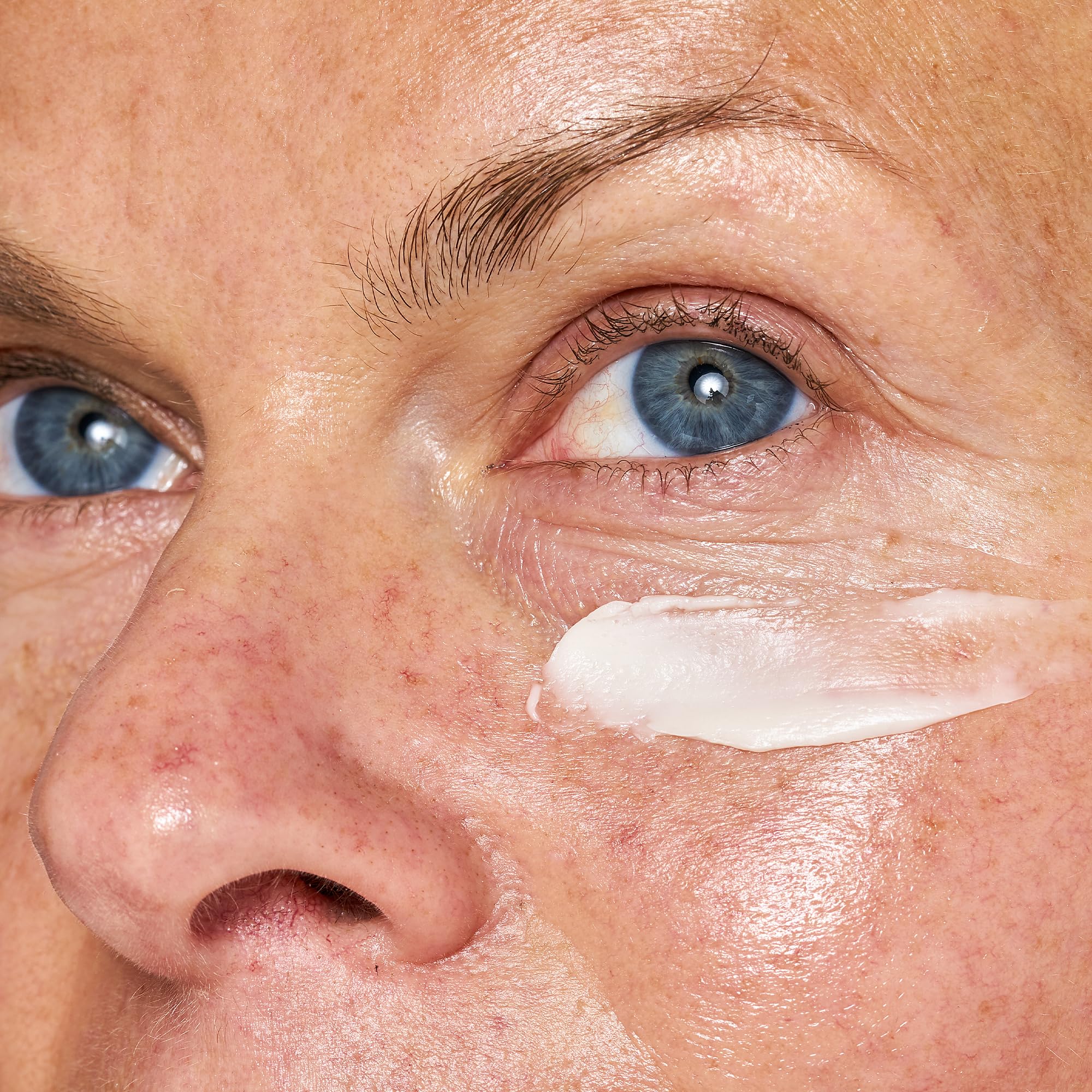 Applying OSEA Advanced Repair Eye Cream under the eye area for refreshed appearance.