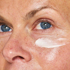 Applying OSEA Advanced Repair Eye Cream under the eye area for refreshed appearance.