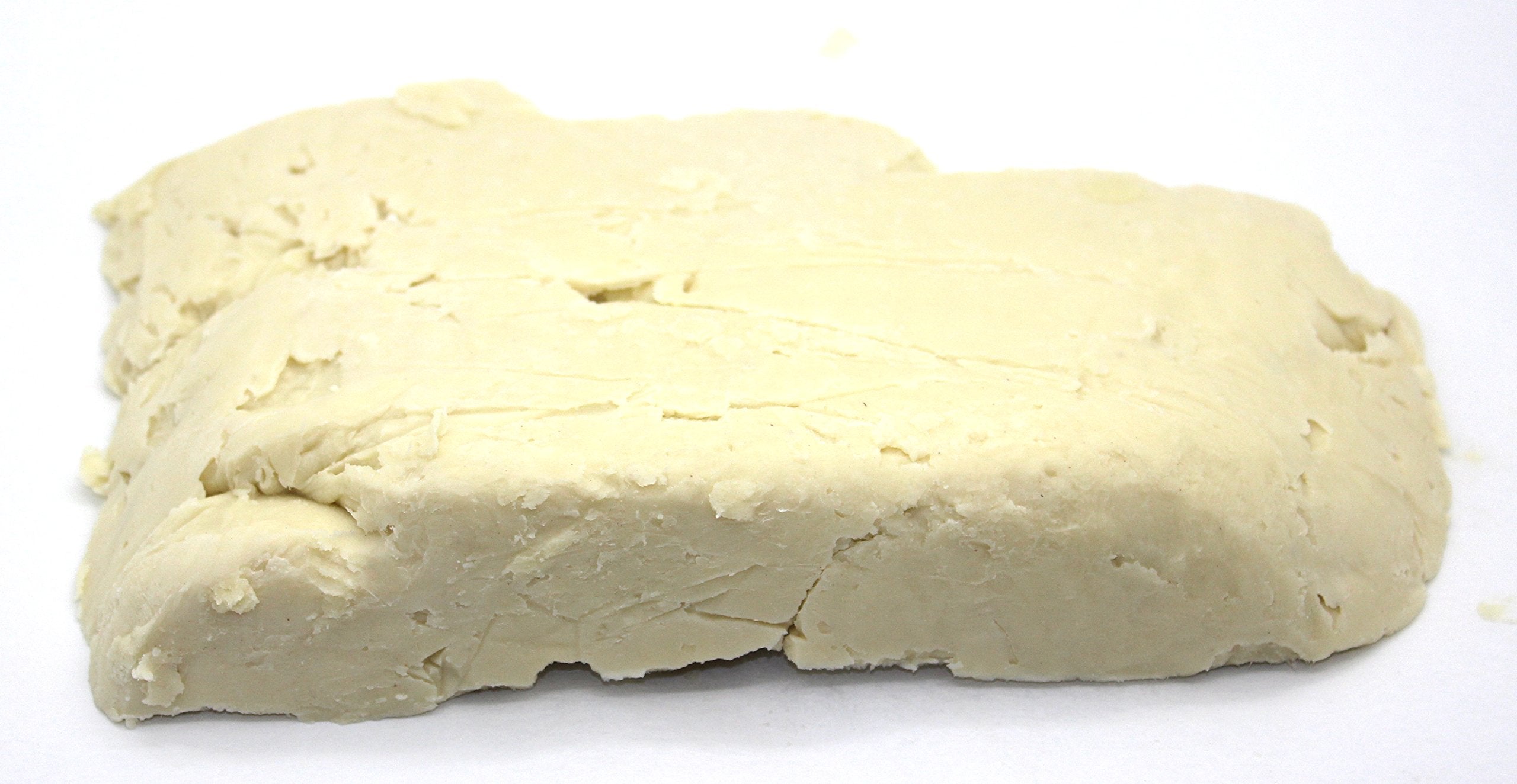 Our Earth's Secrets Ivory Shea butter close-up showing creamy texture for nourishing skin.