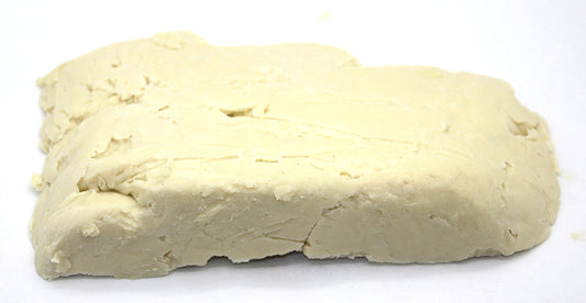 Our Earth's Secrets Ivory Shea butter close-up showing creamy texture for nourishing skin.