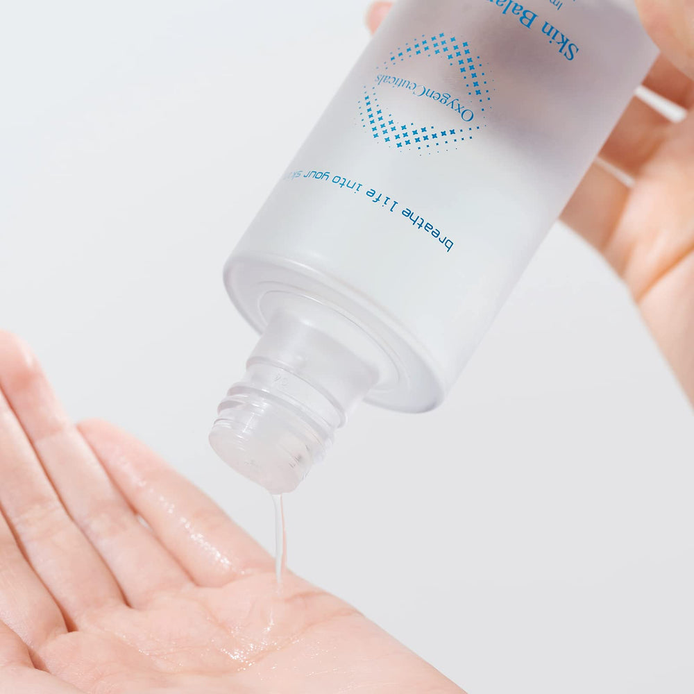 OxygenCeuticals Toner applied with cotton pad to refine texture.