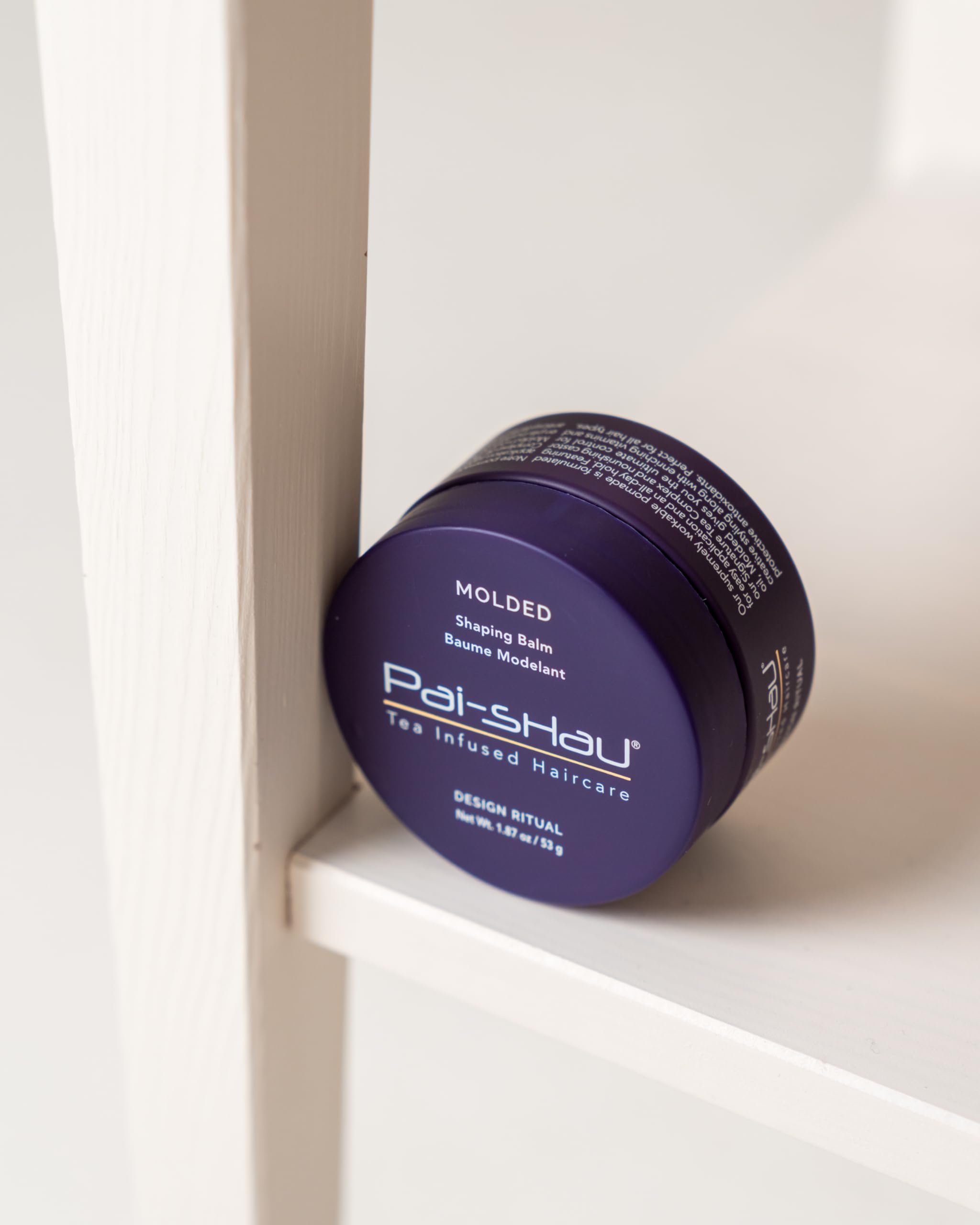Close-up of Pai-Shau Molded balm texture showing nourished strands.
