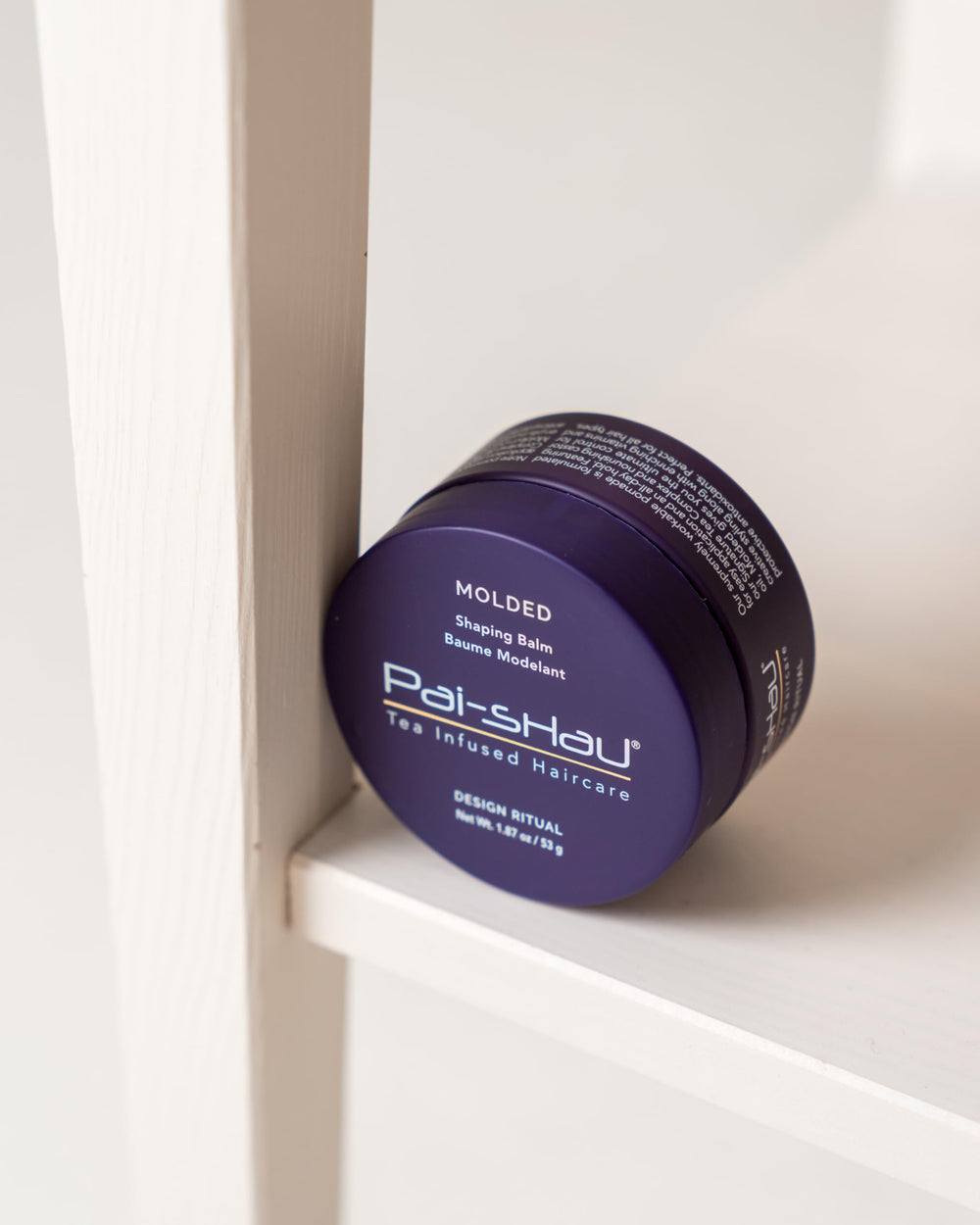 Close-up of Pai-Shau Molded balm texture showing nourished strands.