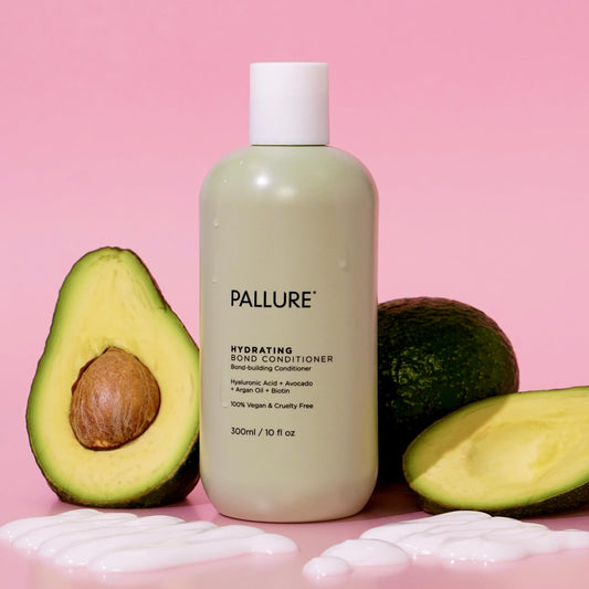 Pallure conditioner being applied to wet hair for even coverage
