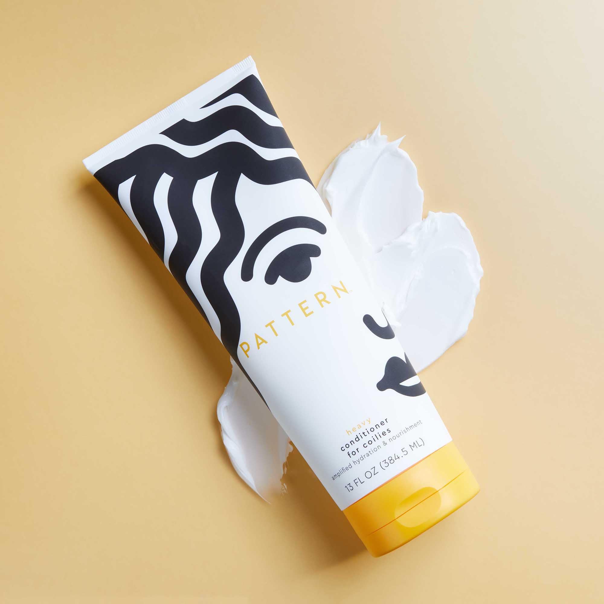 PATTERN Heavy Conditioner in shower-ready shot shows curl definition during rinse.