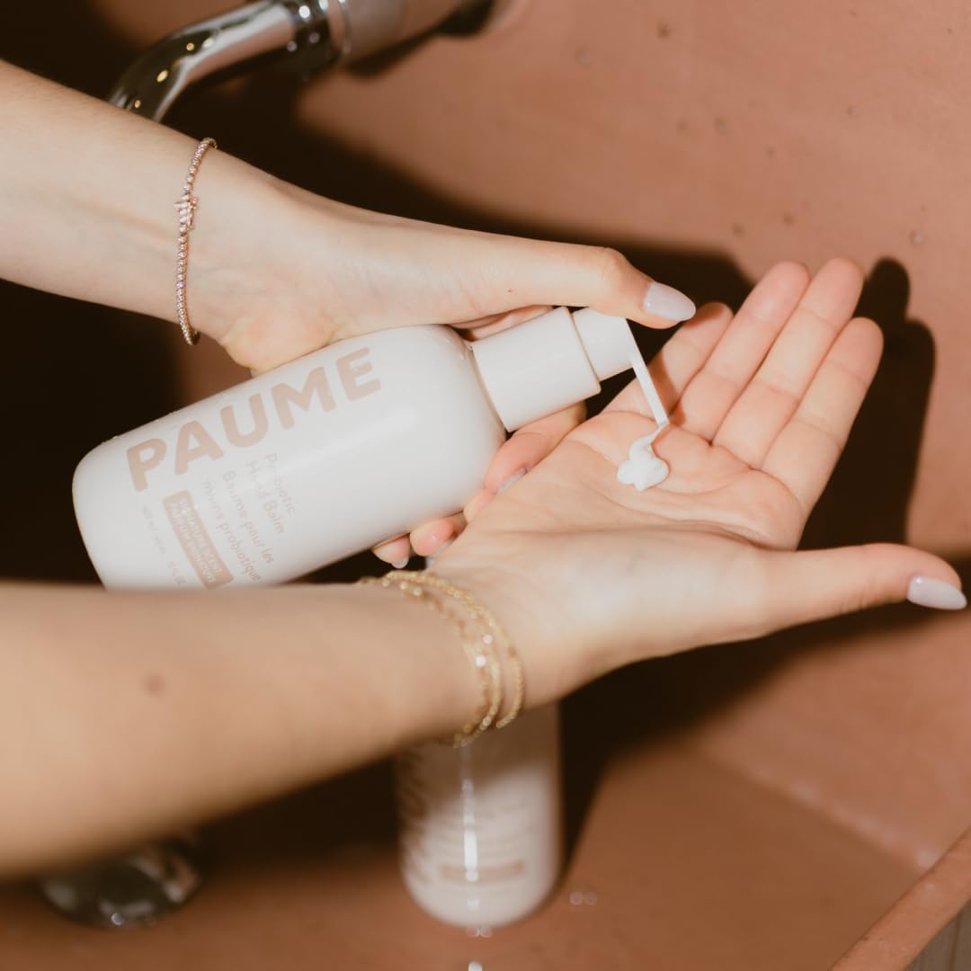 PAUME Probiotic Hand Balm on dry hands illustrating lasting hydration