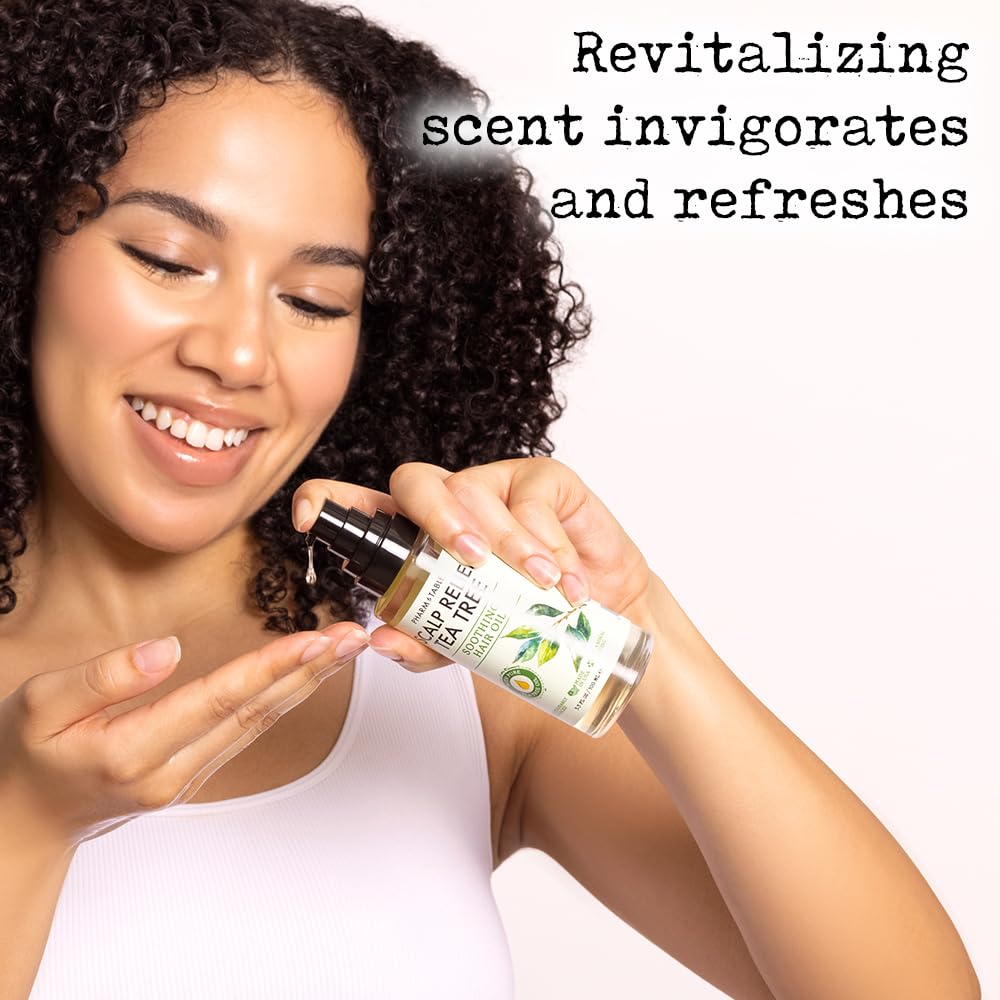 PHARM TO TABLE Tea Tree Hair Oil on hair strands delivering shine and bounce.