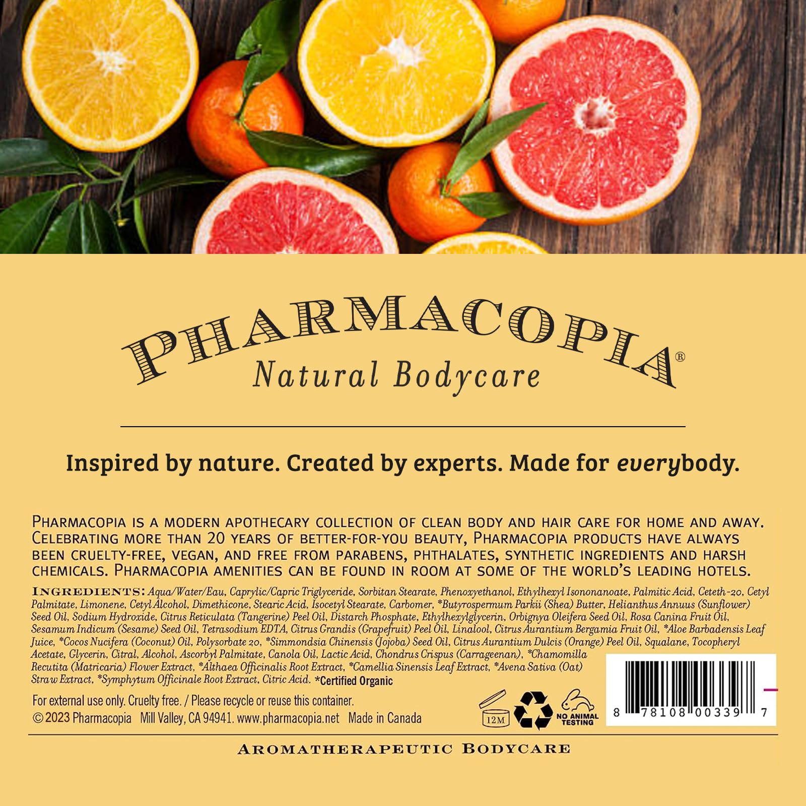 Pharmacopia Citrus Shampoo on shelf with citrus fruits conveying vibrant aroma