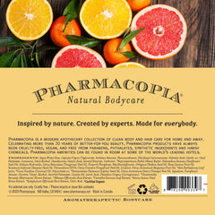 Pharmacopia Citrus Shampoo on shelf with citrus fruits conveying vibrant aroma
