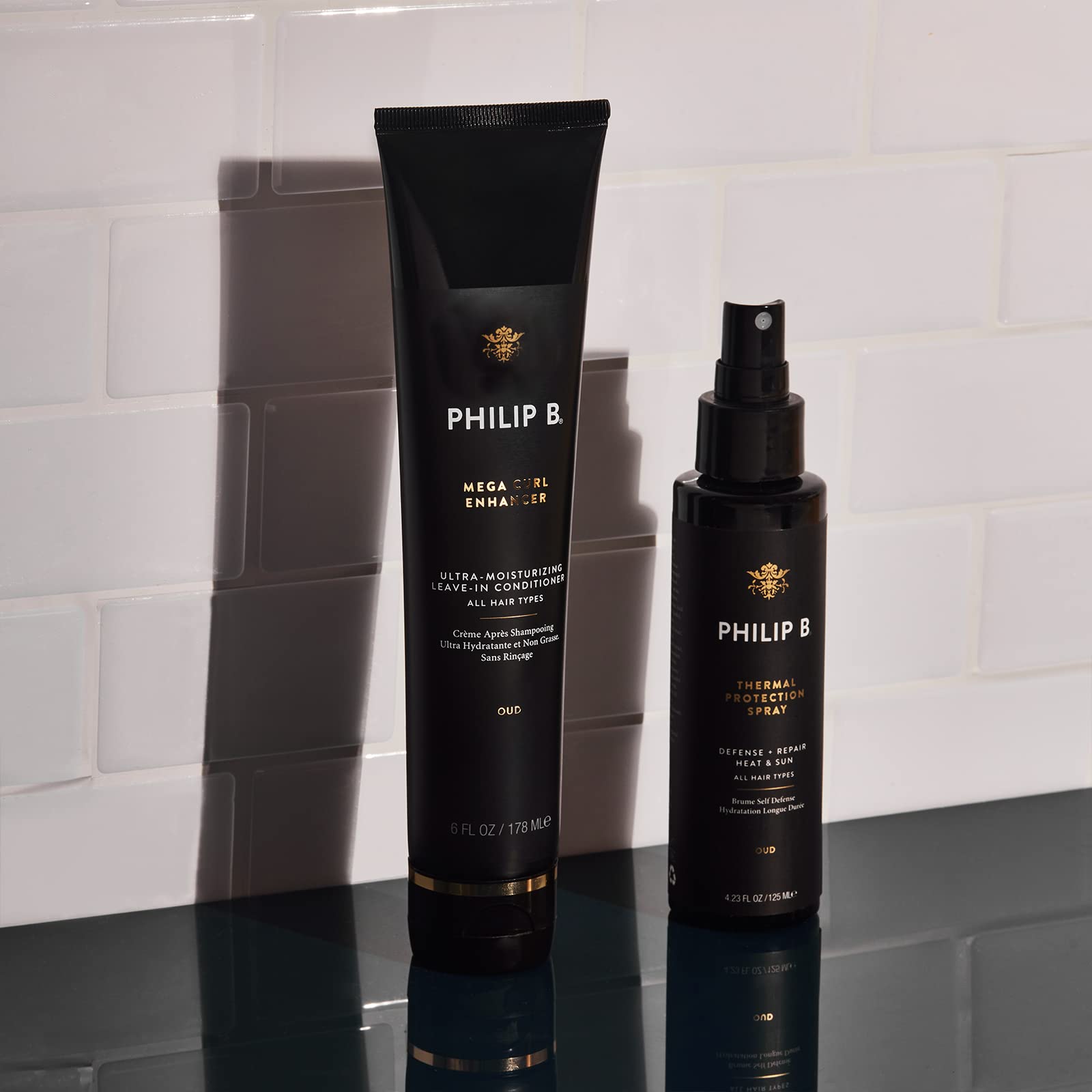 PHILIP B Thermal Protection Spray Oud scent release shown in a subtle audience cue.