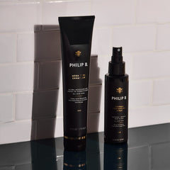 PHILIP B Thermal Protection Spray Oud scent release shown in a subtle audience cue.