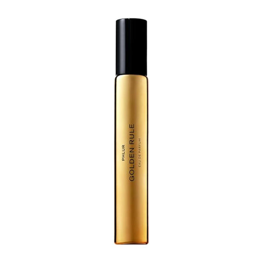 PHLUR Golden Rule bottle close-up with sleek glass for travel-friendly use.