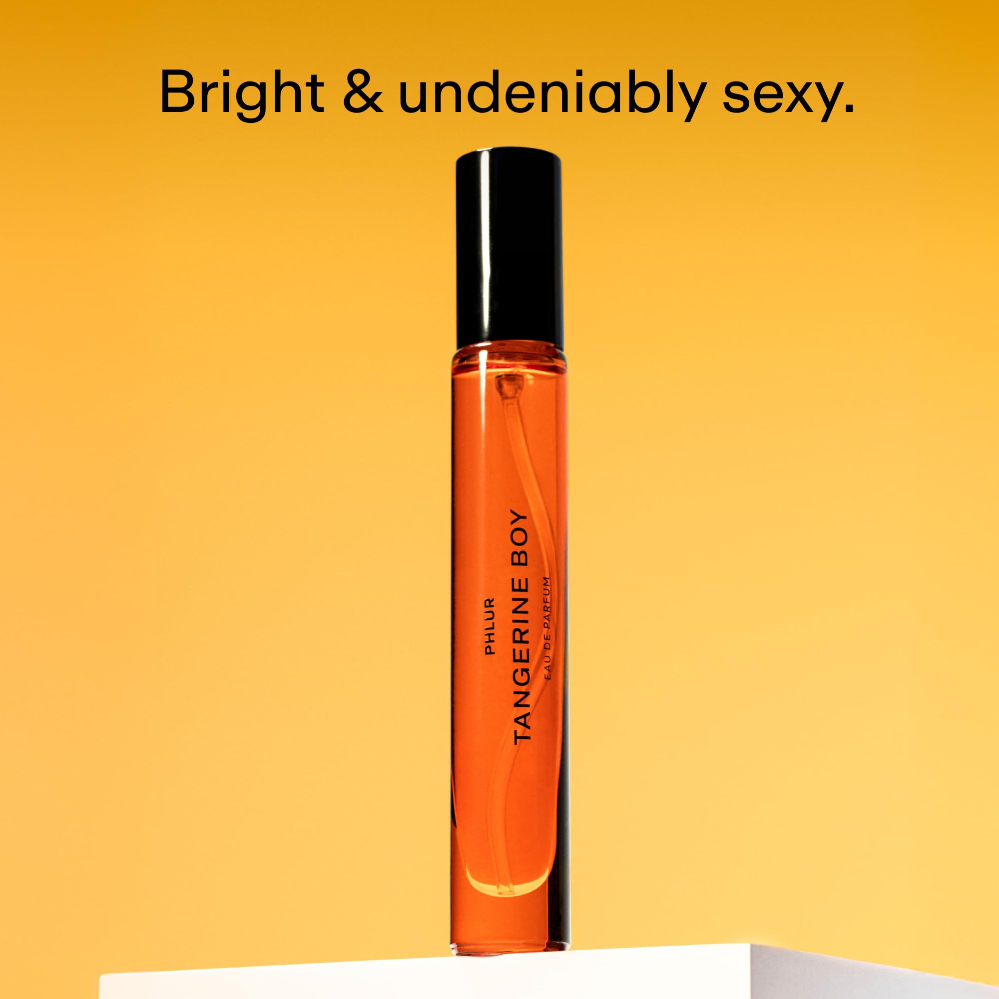 PHLUR Tangerine Boy bottle cap close-up highlights bold citrus and spice.
