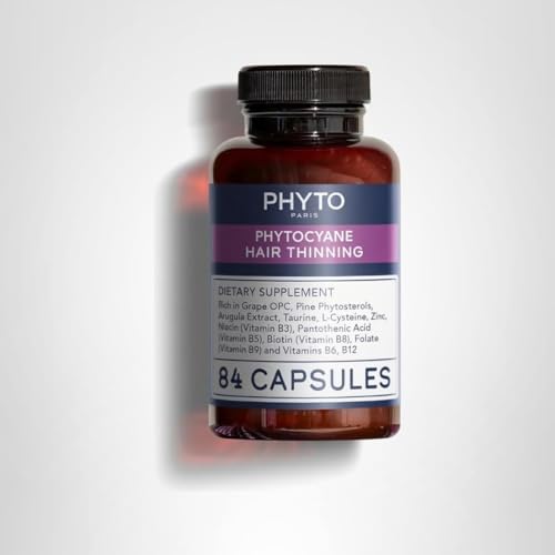 PHYTOCYANE capsules in hand suggesting daily routine for hair support.