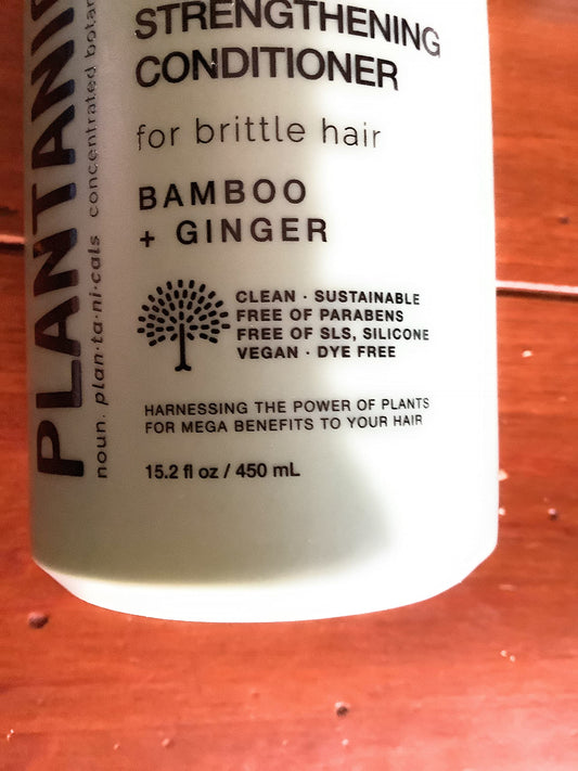 Plantanicals bamboo-ginger conditioner pump top closeup highlighting nourishing formula for smooth usage.
