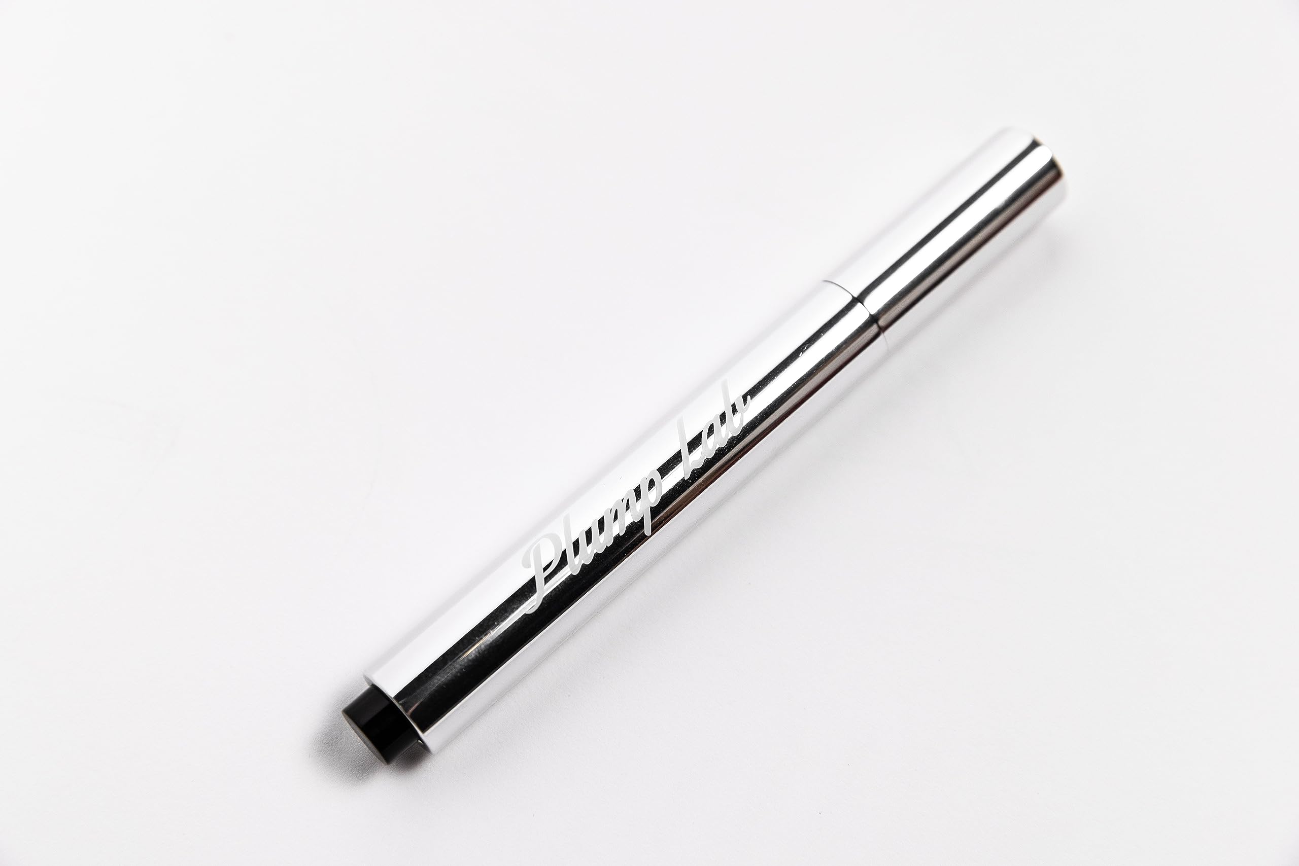 Plump Lab lip plumper gloss clear swatch demonstrates a glossy finish and hydration.