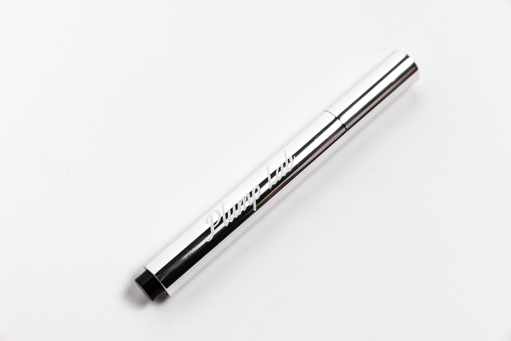 Plump Lab lip plumper gloss clear swatch demonstrates a glossy finish and hydration.