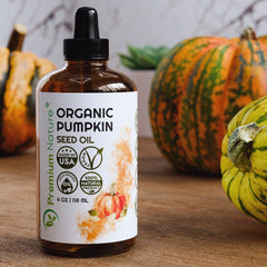 Pumpkin seed oil on hair strand delivering natural shine and nourishment.