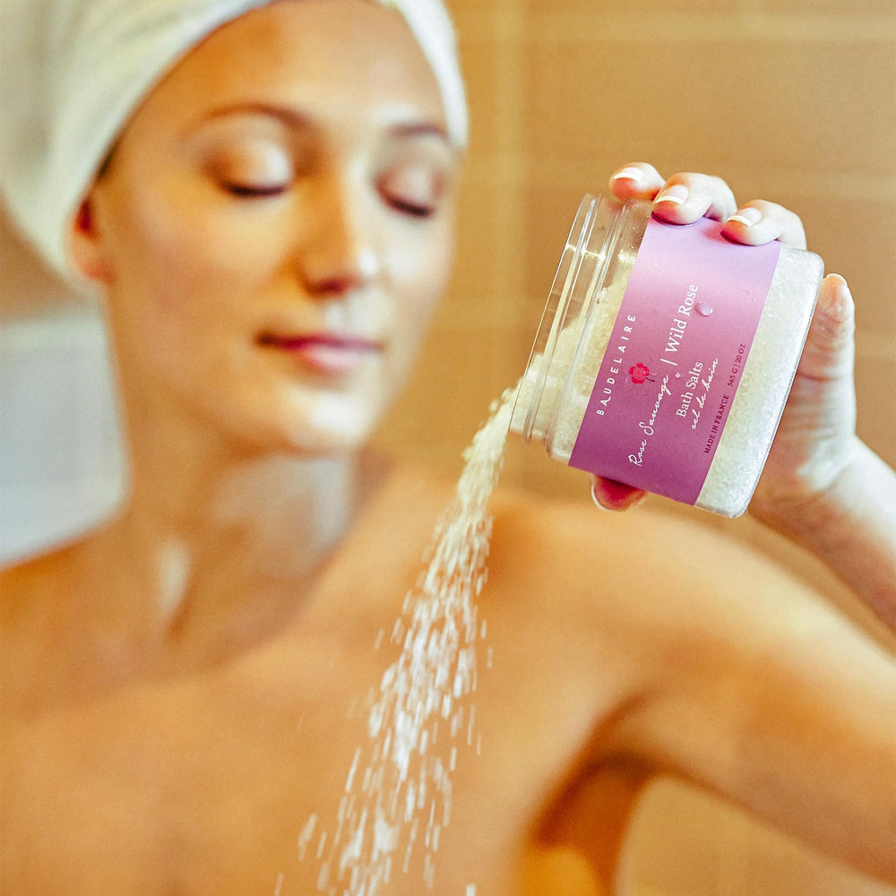 Glass bath salt jar resting on a bath scene