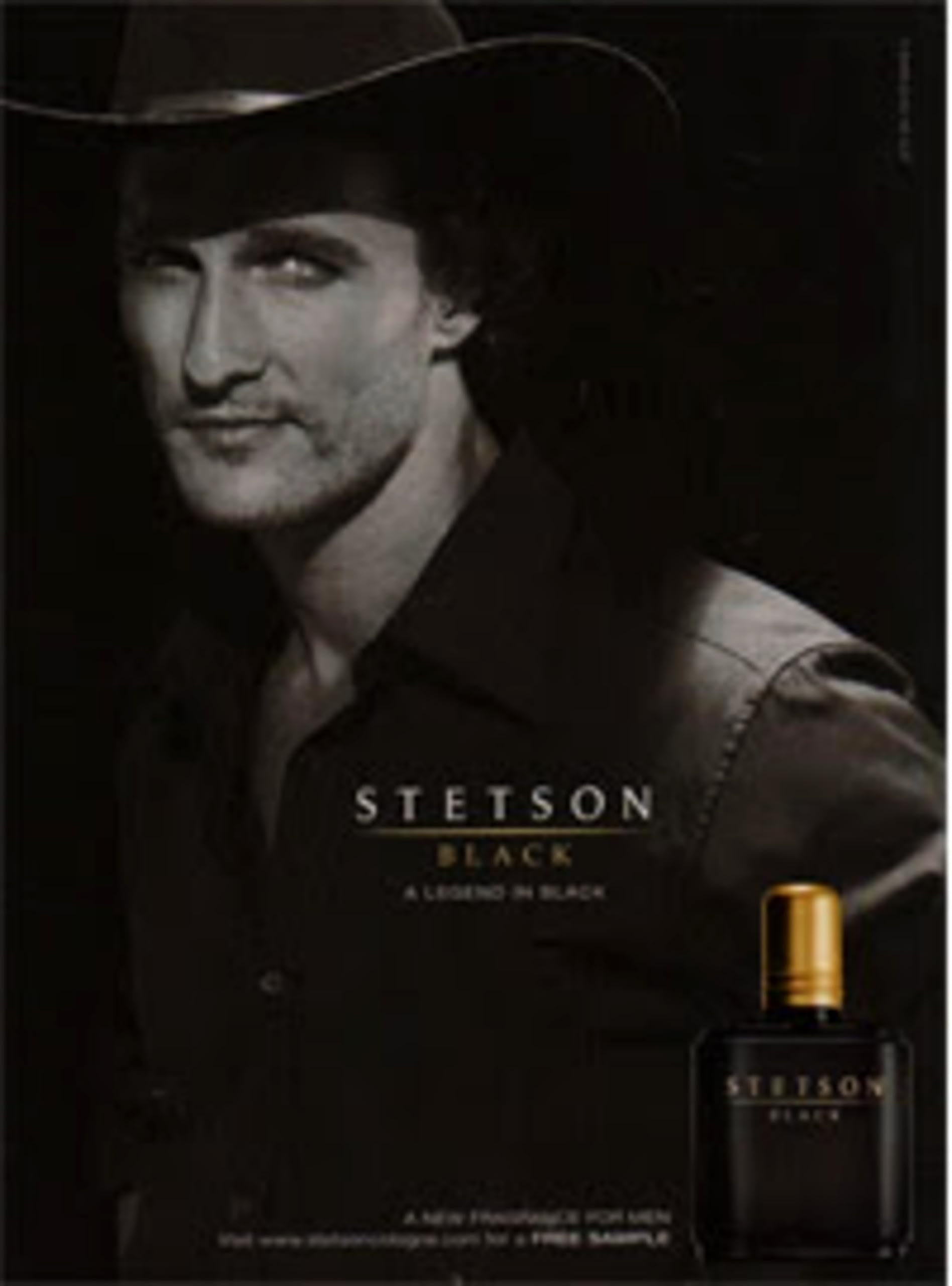 Man applying PureScents Stetson Black aftershave, emphasizing masculine woody scent