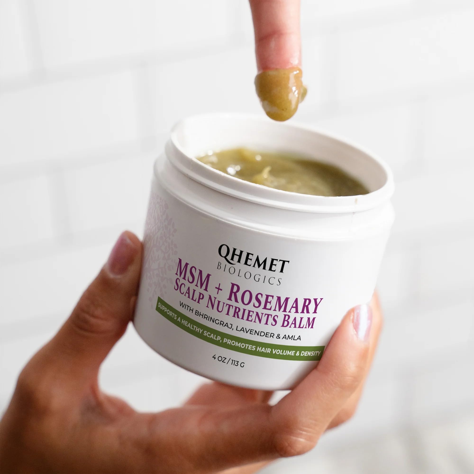 Qhemet Biologics MSM + Rosemary Scalp Balm applied to the scalp for nourishment.