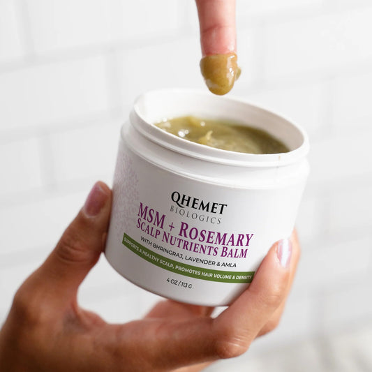 Qhemet Biologics MSM + Rosemary Scalp Balm applied to the scalp for nourishment.