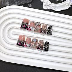Qicaijia black French tip nails with charms for party-ready style.