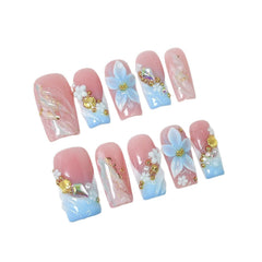 Qicaijia medium square nails close-up with rhinestones and shine.