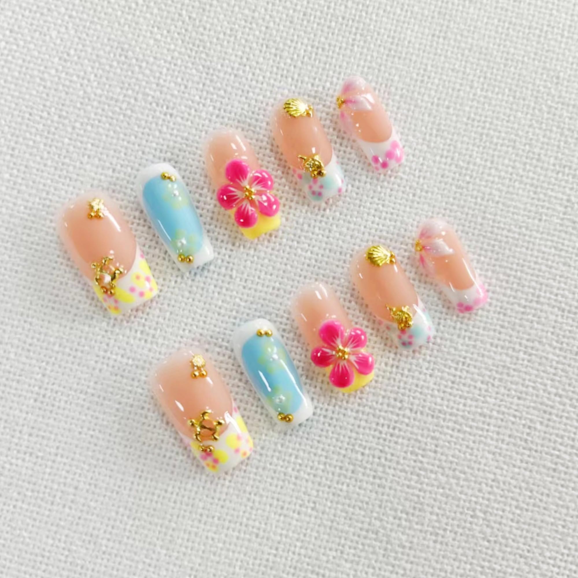 Qicaijia luxury French tip nails with rhinestones for a sophisticated look.