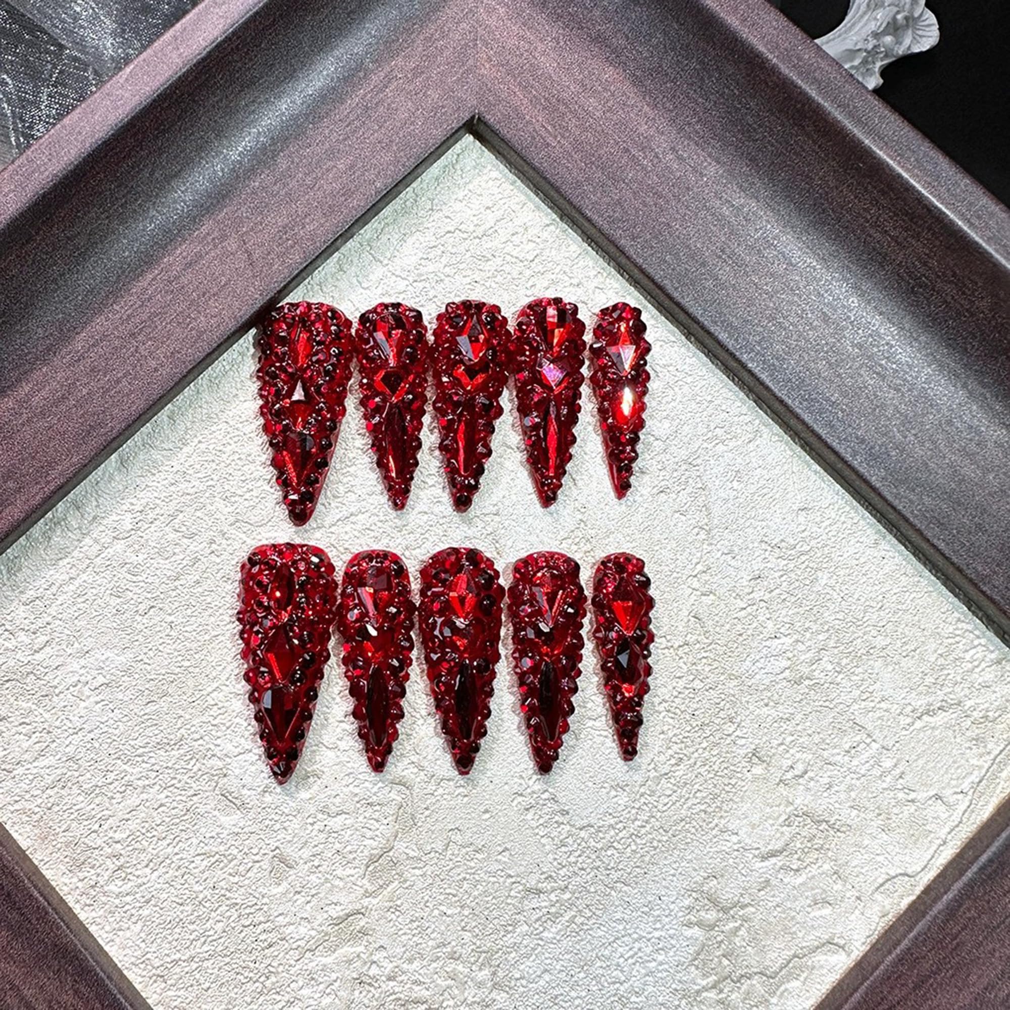 Qicaijia nails with sparkly red rhinestones for glamorous detail