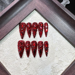 Qicaijia nails with sparkly red rhinestones for glamorous detail
