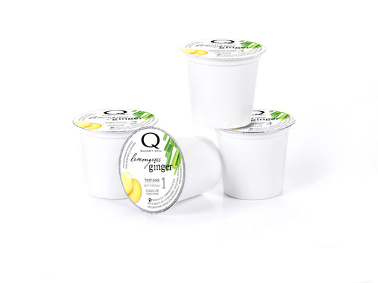 QTICA SmartPods for Fresh Soak and Sugar Scrub demonstrating controlled portions in a spa setting.
