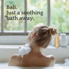 QUR in bathroom lifestyle shot applying lotion after shower for hydration