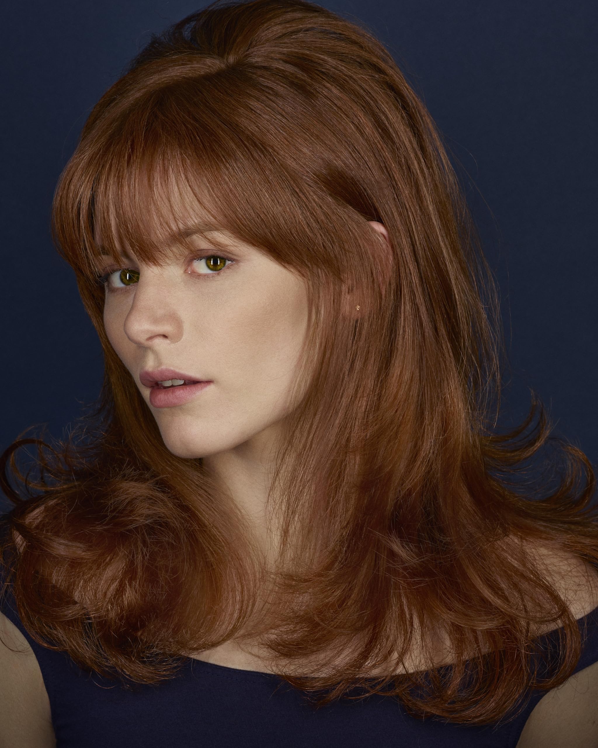 Hands apply BLEU mist on damp hair to reduce frizz and add softness