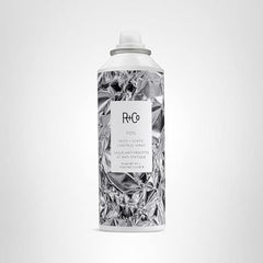 Hair after applying R+Co Foil Frizz + Static Control Spray shows smooth, static-free results.