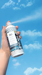 R+Co Halfpipe bottle in-hand displays texture-ready spray.