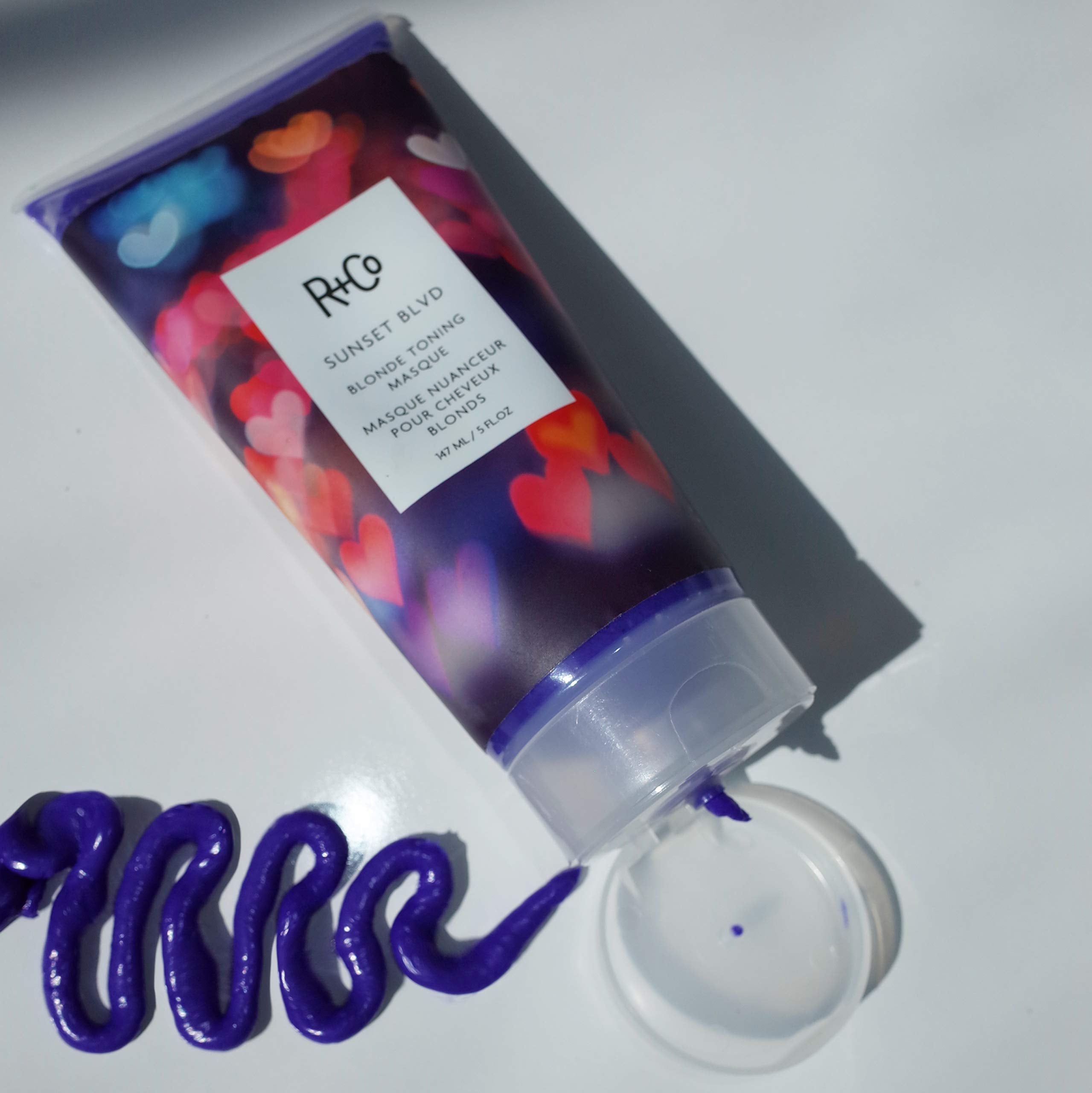 R+Co Sunset Blvd toning creme pump in hand to reduce brassiness