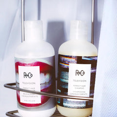 R+Co Television Shampoo lather on wet hair demonstrates cleansing action and refreshment.