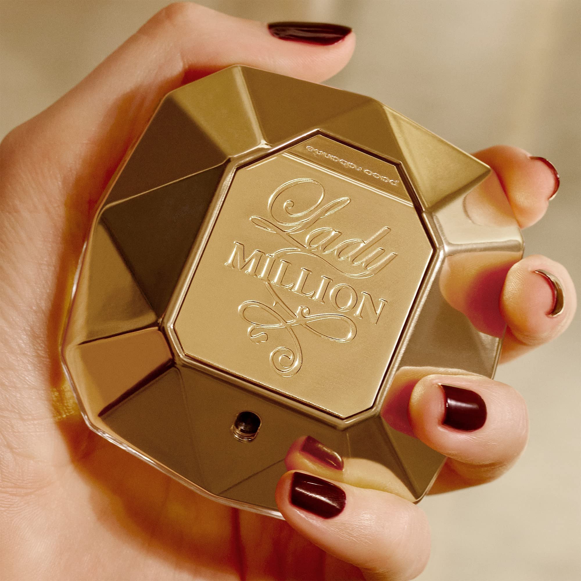 Rabanne Lady Million bottle on warm surface ideal for daytime glamour and scent presence.