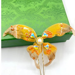 Rabithenn orange butterfly wings close-up highlighting translucent resin and craftsmanship.