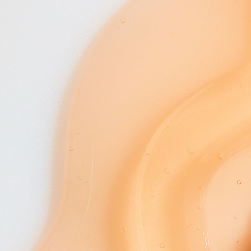 Rahua Enchanted Island Shampoo splash conveying tropical freshness and hydration.