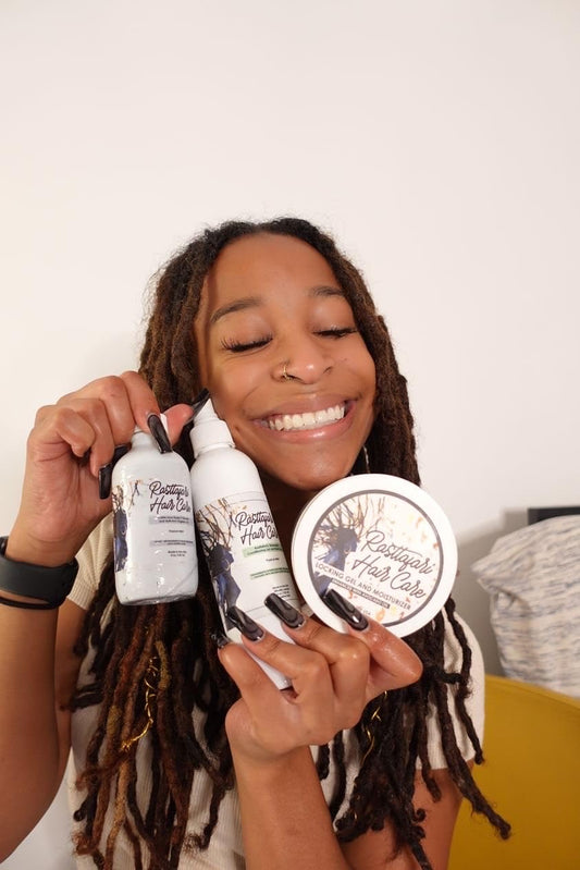Close-up of Rasttafari Rosewater and Mint Conditioning Spray mist on locs.